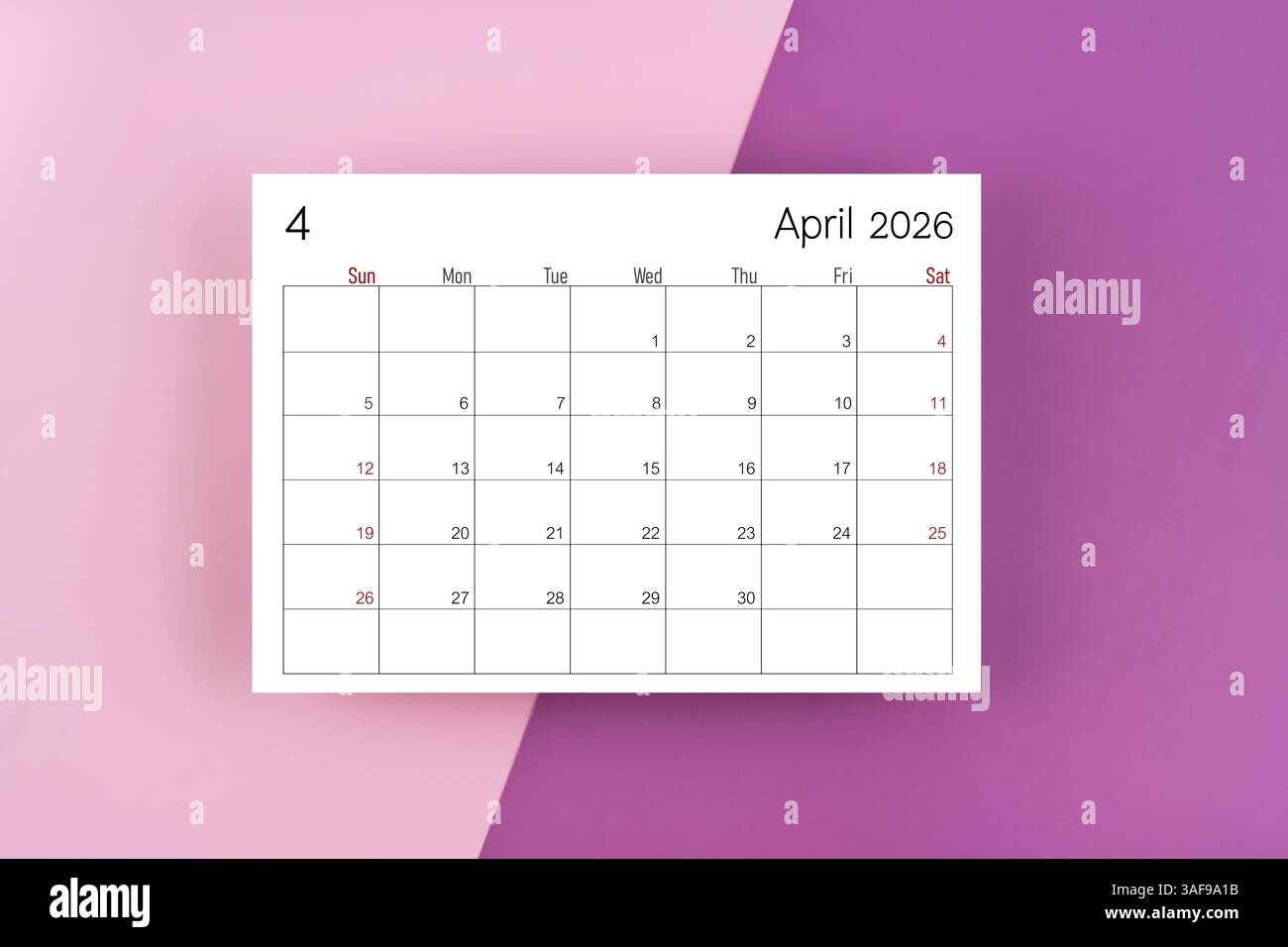 Top View Of April 2026 Calendar On Black Notepad With Yellow 